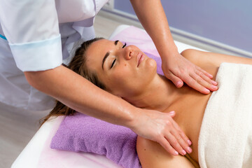 Fototapeta na wymiar Facial massage. A woman is given a massage in a beauty salon. Close-up.