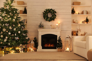 Stylish living room interior with decorated Christmas tree and comfortable sofa