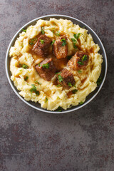 Traditional Greek veal Sofrito straight from the island of Corfu served with mashed potatoes closeup in the plate on the table. Vertical top view from above
