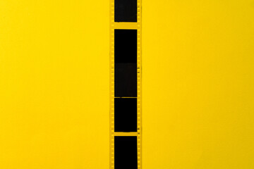 Old vintage film for a camera on yellow background