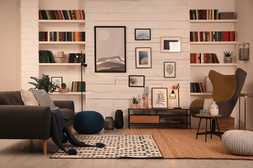 Cozy home library interior with comfortable furniture and collection of different books on shelves © New Africa