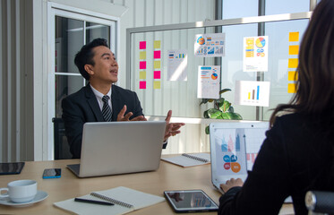 Company executive presenting new management strategy to team in