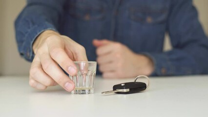 Don't drink and drive concept. Close up of man hand drinking whisky and holding car keys. Responsibly and safety driving - Powered by Adobe
