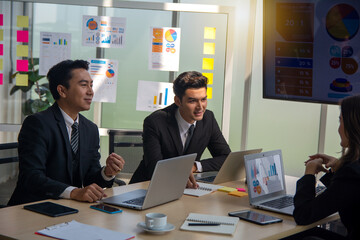 Coworker and brainstorm together in meeting room. Teamwork meeting for discuss sale, cost in company and trends in this year.