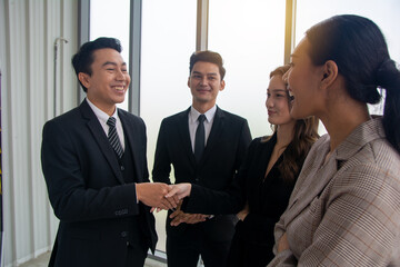 Asian Business people shaking hands, finishing up a meeting, mis