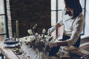 Table setting. A woman decorates the table for the holiday. High quality photo