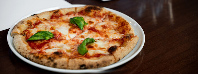 Horizontal banner or header Close-up Italian pizza Margherita on table.