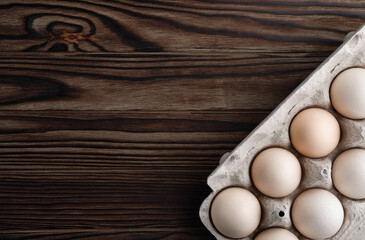 farm chicken fresh eggs from free range in egg cups on wooden background. Conceptual farm products and organic products, rural and healthy dairy products Copy space or blank space for text