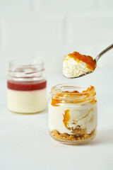 Cakes in jars on a white background. Sweet desserts