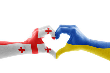 Two hands in the form of heart with Georgian and Ukrainian flag isolated on white background