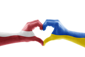 Two hands in the form of heart with Latvian and Ukrainian flag isolated on white background