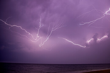 Thunder and lightning spread across the sky