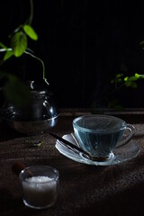 tea pot and cup in dark background 
