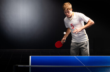 Young sportsman playing table tennis
