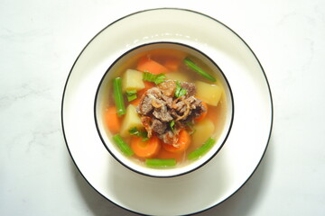 a bowl of beef and vegetables soup 