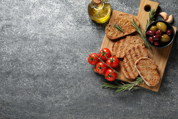 Flat lay composition with bruschettas on grey table, space for text
