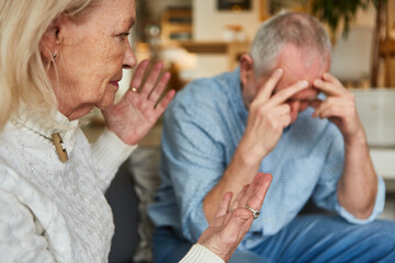 Senior couple having an argument with frustrated man