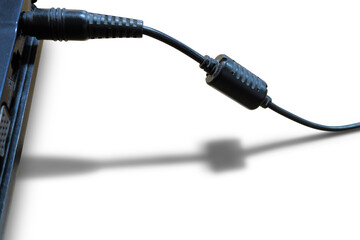 AC DC power supply jack with line shadow on white floor