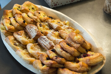 A large plate of desserts, Large selection of food with cold snacks, meat and salads, fruit, cold meats, cheese and jam served. Variety of tasty delicious snacks on the table