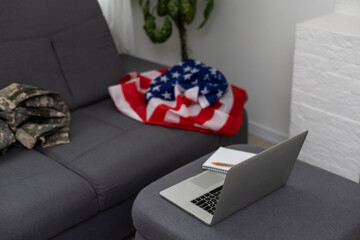 Soldier working with laptop in headquarters building
