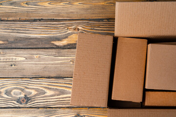 Pile of cardboard boxes on wooden background