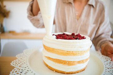 A pastry chef bakes a cake in the home kitchen. Home business.