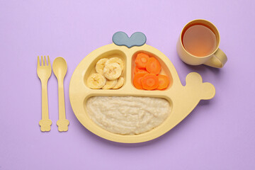 Healthy baby food in plate and cup with drink on violet background, flat lay