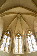 Interior of a european gothic chapel with arches and glass windows