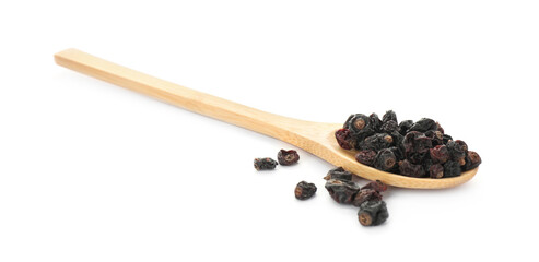 Dried black currants and wooden spoon isolated on white