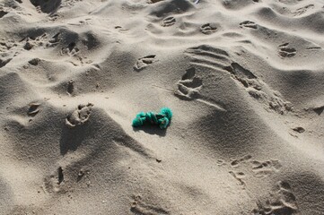 piece of fishing net lying on the beach and pollute the environment
