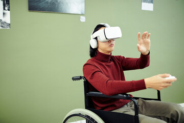 Young Asian man with disability wearing VR headset and headphones visiting contemporary photography...