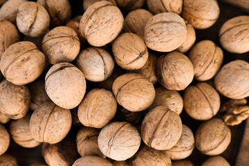 Many tasty walnuts as background, top view