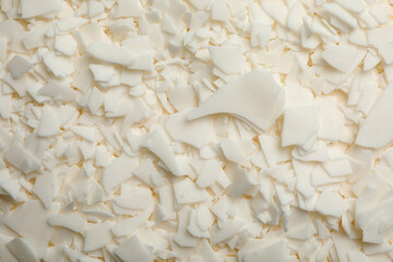 Heap of soy wax flakes as background, top view. Homemade candle material