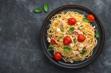 Spaghetti with baked tomatoes and feta cheese.