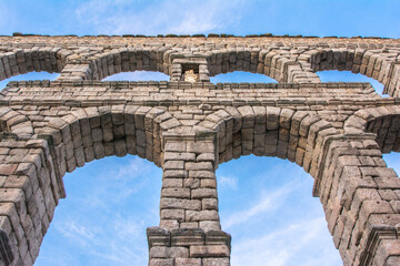 The famous Roman aqueduct of Segovia in Spain. Heritage of humanity by unesco. stone for the...