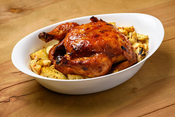 fried chicken meat and roasted potatoes, tasty food on a wooden background
