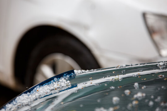 Small Hail Ice Balls On Green Car Hood After Heavy Summer Storm