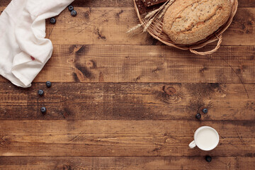 bread and wheat on a wooden table top view
