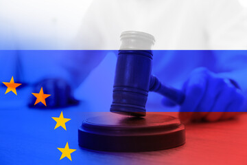 Multiple exposure of judge with gavel, Europenean Union and Russian flags. Concept of sanctions...