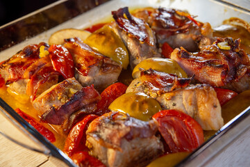 duck with apples and tomatoes baked in an oven