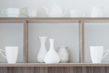 white kitchenware on wooden shelf