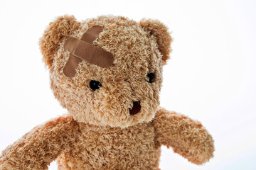 Teddy bear with bandages isolated on white background