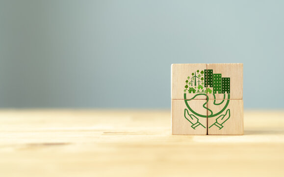 Eco Friendly, Green Company Culture Concept. Carbon Nautral And Net Zero Target. Sustainable Enviroment And Business. Build Green Community. Wooden Cubes With Hand Holding Eco Globe On Grey Background