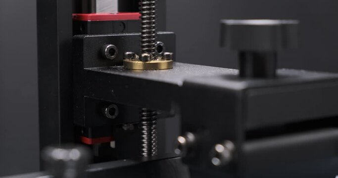 MSLA 3D printer, Linear rail of consumer resin 3D Printer build platfrom moving up and down during 3d printing. MSLA 3D printing. Additive manufacturing