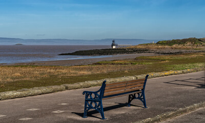 Fototapeta na wymiar Portishead beach from Esplanade Road with view of Battery Point Lighthouse, Somerset, England