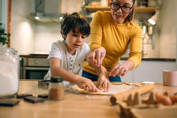 mother and her son baking together in kitchen