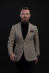 Obraz premium Confident businessman walking forward wearing a causal suit, handsome senior business man hero shot portrait isolated on black
