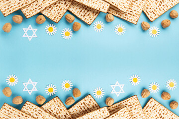Passover greeting card with matzah, nuts daisy and tulip flowers on blue background.