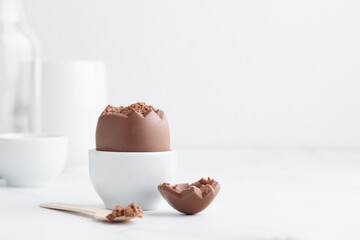 Chocolate easter egg in a white eggholder