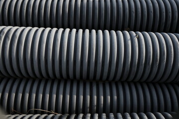 grey plastic corrugated piping stacked 
